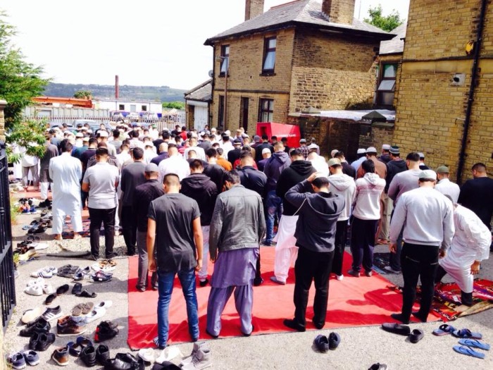 Community prayer overflow at JMN Halifax mosque in West Yorkshire during busy Friday prayers